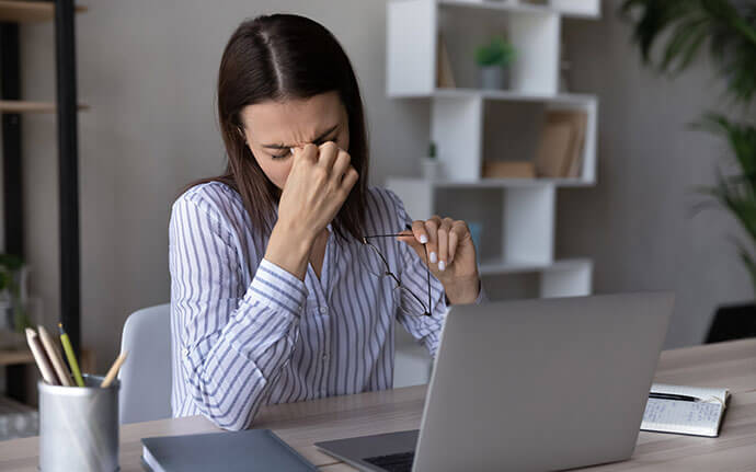 Woman touching her tired eyes