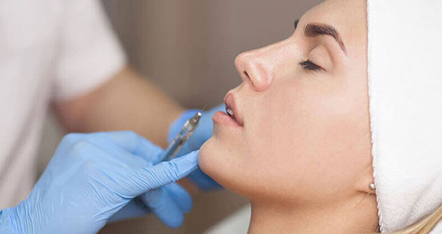 Woman undergoing aesthetics injection