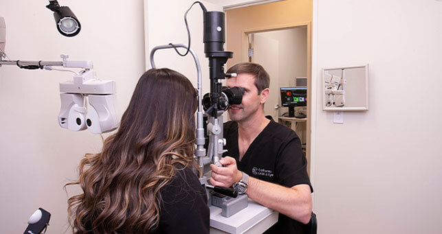 Dr. Barnett giving eye exam to patient