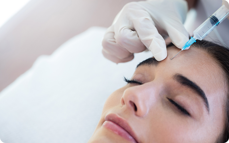 girl-getting-injection woman touching her face after her aesthetic treatments